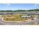 A scenic aerial view reveals a townhome community with a pool, green space and construction area at 3116 Beacon Heights Rd, Indian Land, SC 29707