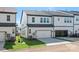 New townhome exterior with a two-car garage, lawn and modern architectural details at 3116 Beacon Heights Rd, Indian Land, SC 29707