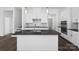 Open concept kitchen with a large center island, dark countertops, and stainless steel appliances at 3116 Beacon Heights Rd, Indian Land, SC 29707