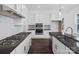 Modern kitchen features stainless steel appliances, gas cooktop, dark countertops, and white cabinetry at 3116 Beacon Heights Rd, Indian Land, SC 29707