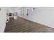 Bright, open-concept living room with luxury vinyl plank flooring connecting to kitchen with stainless appliances at 3116 Beacon Heights Rd, Indian Land, SC 29707