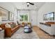 Bright living room with leather sofa and large windows at 3116 Beacon Heights Rd, Indian Land, SC 29707