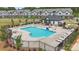 Community pool featuring abundant lounge chairs and umbrellas, set among townhouse style homes and lush greenery at 3116 Beacon Heights Rd, Indian Land, SC 29707