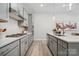 Modern kitchen with gray cabinets, quartz countertops, and stainless steel appliances at 3120 Beacon Heights Rd, Indian Land, SC 29707