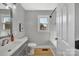 Updated bathroom with gray vanity, white tub, and mosaic tile accents at 3433 Grey Rd, Davidson, NC 28036