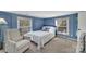 Bright bedroom with a double bed, chair, and large windows at 3433 Grey Rd, Davidson, NC 28036
