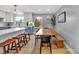 Dining area with a long wooden table, black chairs, and a built-in bench at 3433 Grey Rd, Davidson, NC 28036