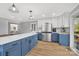 Modern kitchen with white and blue cabinets, a large island, and stainless steel appliances at 3433 Grey Rd, Davidson, NC 28036