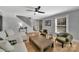 Living room with white sofa, green chairs, and a wood-paneled accent wall at 3433 Grey Rd, Davidson, NC 28036