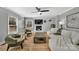 Living room with a fireplace, light-colored sofa, and two green armchairs at 3433 Grey Rd, Davidson, NC 28036