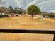 Large fenced pasture with a red barn and picnic table at 3433 Grey Rd, Davidson, NC 28036