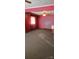 Living room with red walls, ceiling fan, and carpeted floor at 3706 2Nd Nw Ave, Hickory, NC 28601