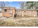 Back exterior of a brick home with utility connections and a partially visible backyard at 445 Providence Rd, Lancaster, SC 29720