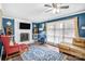 Bright living room featuring a painted brick fireplace, ample natural light, and comfortable seating area at 445 Providence Rd, Lancaster, SC 29720