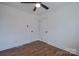 This simple bedroom features neutral walls, hardwood floors, and a ceiling fan at 6305 Dale Ave, Charlotte, NC 28212