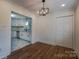 Bright dining room with hardwood floors and a modern light fixture, open to the adjacent kitchen at 6305 Dale Ave, Charlotte, NC 28212