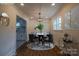 Elegant dining room with modern lighting, sleek hardwood floors, and a view into the kitchen at 6305 Dale Ave, Charlotte, NC 28212