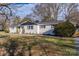 Charming single-story home with painted brick, black shutters, and mature landscaping at 6305 Dale Ave, Charlotte, NC 28212