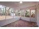 Enclosed sunroom featuring brick flooring and an open view to a large backyard at 6305 Dale Ave, Charlotte, NC 28212