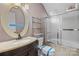 Bright bathroom featuring a vanity, toilet, shower, and oval mirror at 69 Honeysuckle Woods, Clover, SC 29710