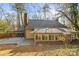 Rear view of house showcasing a sunlit deck and large windows at 69 Honeysuckle Woods, Clover, SC 29710