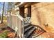 Brick steps leading up to a wooden deck, offering access to the home at 69 Honeysuckle Woods, Clover, SC 29710