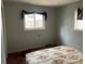 Simple bedroom with floral bedding and a window at 1108 Cone Ave, Pineville, NC 28134