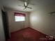 Small bedroom with pink carpet and ceiling fan at 1108 Cone Ave, Pineville, NC 28134