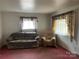 Living room with brown sofa and matching armchair at 1108 Cone Ave, Pineville, NC 28134