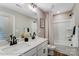 Bathroom featuring double sink vanity, framed mirror, and a separate toilet and tub/shower combination at 128 Ballantree Rd # 46, Mooresville, NC 28115