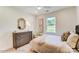 Comfortable bedroom featuring a large window, dresser, and neutral decor at 128 Ballantree Rd # 46, Mooresville, NC 28115