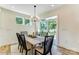 Bright dining area featuring a modern light fixture, table for six, and a view of the backyard at 128 Ballantree Rd # 46, Mooresville, NC 28115
