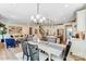 Open dining area with modern chandelier, connects to kitchen, living room, and staircase in a bright space at 128 Ballantree Rd # 46, Mooresville, NC 28115