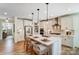 Stylish kitchen with white cabinets, stainless steel appliances, island with seating, and elegant backsplash at 128 Ballantree Rd # 46, Mooresville, NC 28115