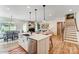 Bright kitchen with a center island, stainless steel sink, and an open view of the dining and living areas at 128 Ballantree Rd # 46, Mooresville, NC 28115
