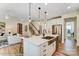 Open-concept kitchen with a large island, stainless steel sink, and a view of the living room and staircase at 128 Ballantree Rd # 46, Mooresville, NC 28115