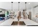 Spacious kitchen island with stainless sink overlooks living and dining rooms, staircase, and modern decor at 128 Ballantree Rd # 46, Mooresville, NC 28115