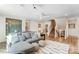 Spacious living area with a gray sectional, natural light, and staircase at 128 Ballantree Rd # 46, Mooresville, NC 28115