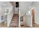 Bright staircase with wood and carpet steps, showcasing the home's architecture and a glimpse of the living area at 128 Ballantree Rd # 46, Mooresville, NC 28115