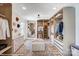 Spacious walk-in closet with custom shelving, mirror, and a center ottoman for added convenience and style at 128 Ballantree Rd # 46, Mooresville, NC 28115