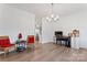 Bright dining room with hardwood floors and red accent chairs at 14247 Canemeadow Dr, Charlotte, NC 28278