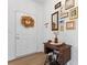 Entryway with antique sewing machine table and wall gallery at 14247 Canemeadow Dr, Charlotte, NC 28278