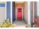 Red front door with wreath, brick and siding exterior at 14247 Canemeadow Dr, Charlotte, NC 28278