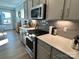 Modern kitchen with stainless steel appliances, stylish cabinets, and countertop details at 14247 Canemeadow Dr, Charlotte, NC 28278