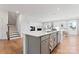Modern kitchen with gray island, white countertops, and hardwood floors at 14247 Canemeadow Dr, Charlotte, NC 28278
