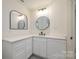 Chic bathroom featuring modern sinks, round mirrors and light countertops at 177 Olympia Dr, Mooresville, NC 28117