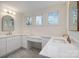 Bright bathroom with dual sinks, white cabinetry, quartz countertops, and large mirrors at 177 Olympia Dr, Mooresville, NC 28117