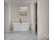 Modern bathroom featuring a freestanding tub, marble floors, and natural light at 177 Olympia Dr, Mooresville, NC 28117