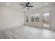 Bright bedroom featuring light wood floors, a ceiling fan, and large windows at 177 Olympia Dr, Mooresville, NC 28117