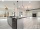 Bright dining area with large windows offering natural light and an adjacent living area with fireplace at 177 Olympia Dr, Mooresville, NC 28117